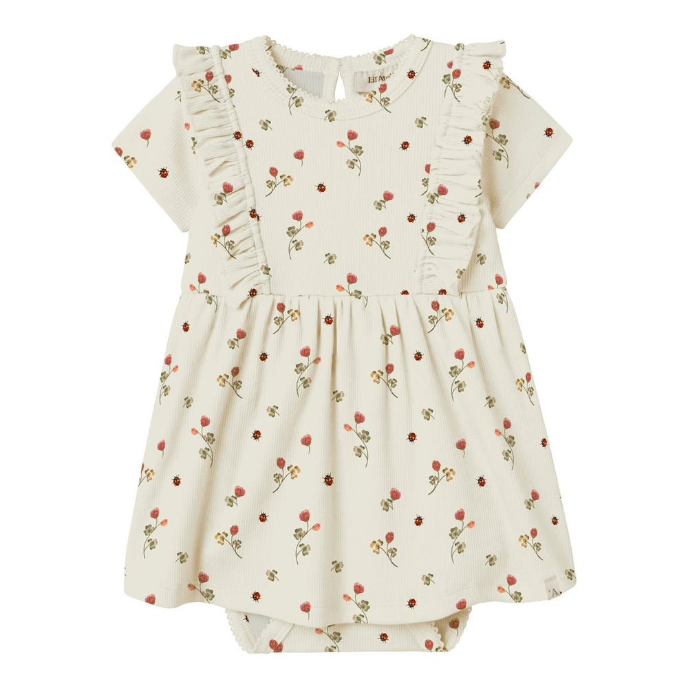 De Lil' Atelier baby lavo ena romperjurk in turtledove is een prachtige jurk die de garderobe van je baby een stijlvolle upgrade geeft. VanZus
