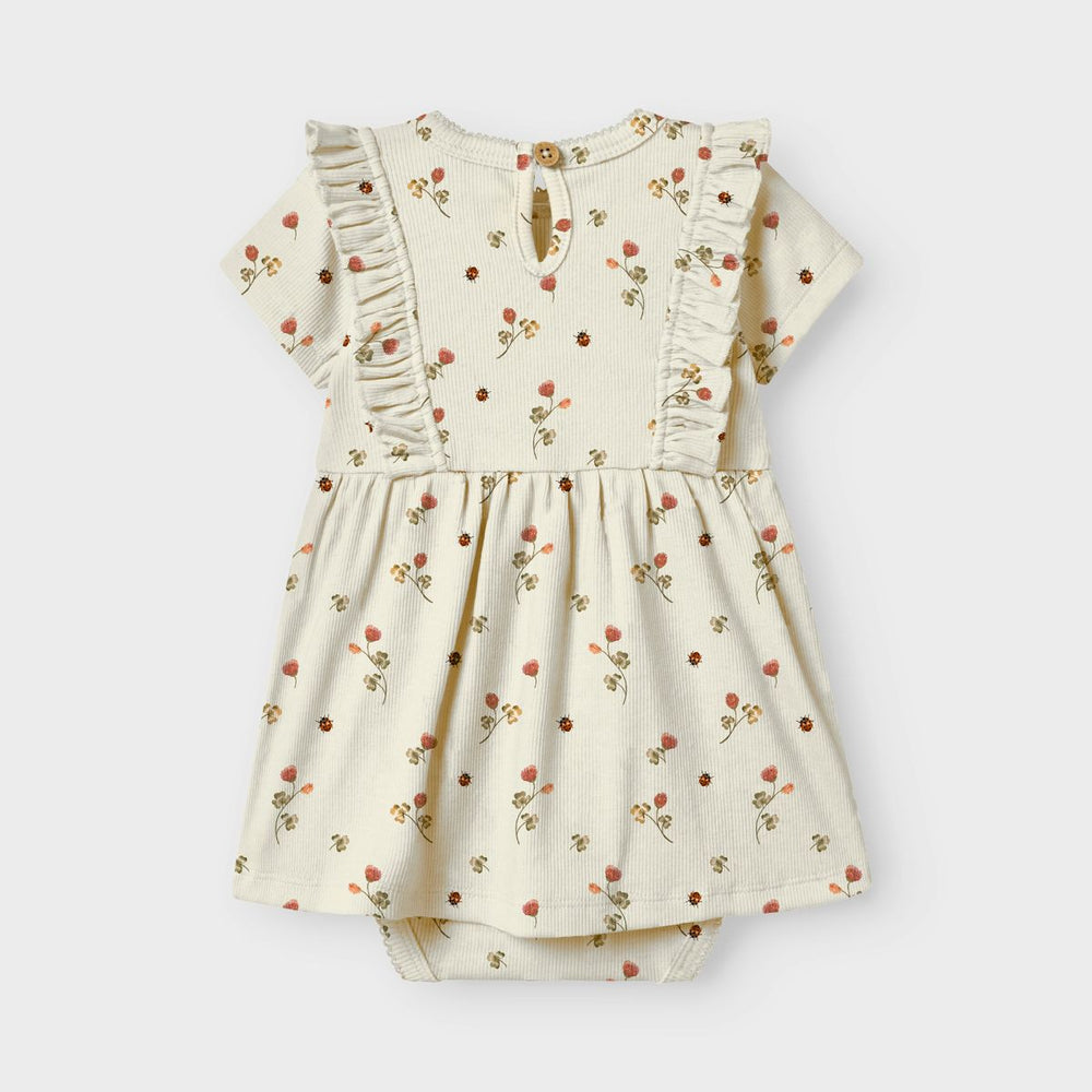 De Lil' Atelier baby lavo ena romperjurk in turtledove is een prachtige jurk die de garderobe van je baby een stijlvolle upgrade geeft. VanZus