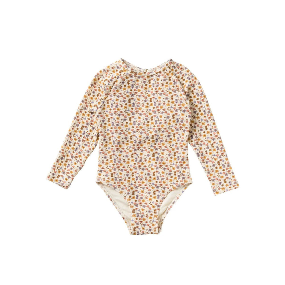 Het Salted Stories flower bud badpak met lange mouwen in shortbread heeft een mooie print van gekleurde bloemen. Het badpak beschermt tegen zon en zout water. VanZus