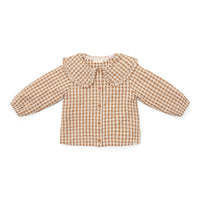 Hoe je de blouse brown check van Little Dutch ook combineert: je meisje zal er geweldig uitzien! De geruite blouse met lange mouwen heeft een bruin-wit patroon en een mooie opvallende kraag met ruches. Zo ziet de blouse er meteen heel bijzonder en meisjesachtig uit. De stof met textuur is van biologisch katoen. VanZus