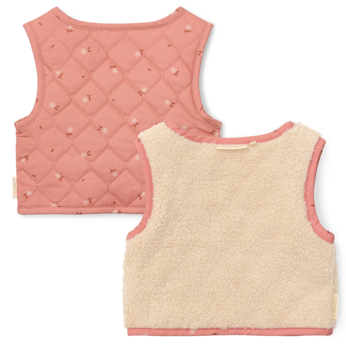 Met het omkeerbaar gilet van Little Dutch in de kleur sand/warm rose blooming flower voeg je een vleugje stijl toe aan de outfit van je kind. Het gilet kan op twee manieren gedragen worden: de kant van de teddystof of de kant met bloemetjesprint. VanZus