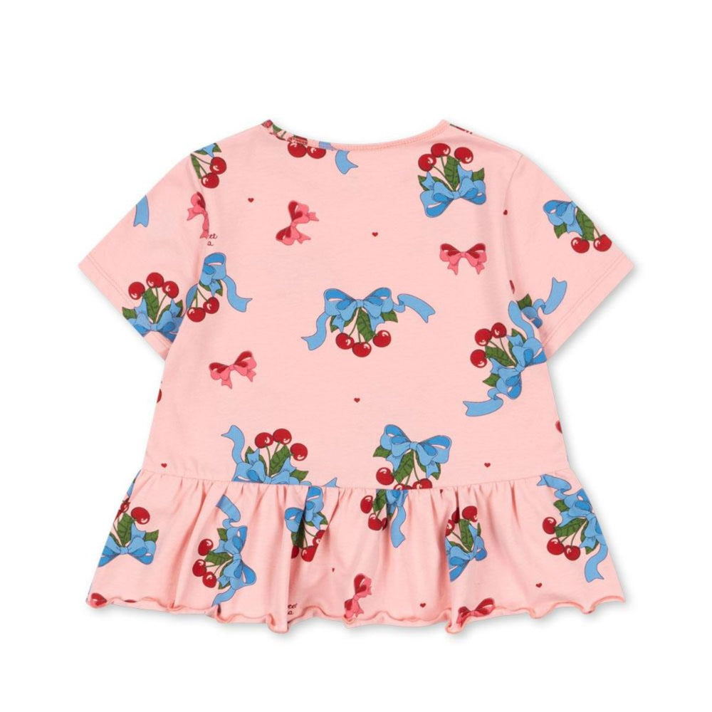 Hoe lief is dit basic frill t-shirt in de variant amarena van het merk Konges Slojd?! Dit mooie t-shirt is net een beetje anders dan anders en maakt van elke outfit een eyecatcher! Het t-shirt is voorzien van een schattige amarena print en heeft een leuk ruchesdetail aan de onderkant. VanZus
