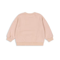 Het Konges Slojd lou glitter sweatshirt cameo rose is een must-have voor elke garderobe. Van zacht biologisch katoen, biedt het comfort en een trendy uitstraling met glitters, perfect voor school of casual uitjes! VanZus