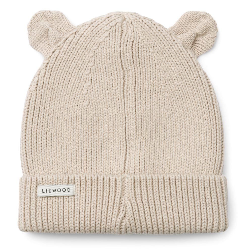 Maak kennis met te leuke gina beanie met oortjes in de kleur sandy van het toffe merk Liewood. Deze muts is de perfecte combinatie van stijl en functionaliteit voor de kleintjes! VanZus