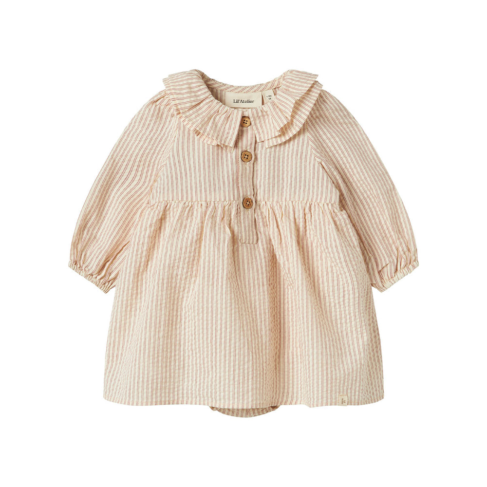 De Lil' Atelier baby Lucia romperjurk in de kleur turtledove is het perfecte kledingstuk voor je kleintje. Deze schattige romperjurk combineert de stijl van een jurk met het gemak van een romper, waardoor het zowel praktisch als trendy is. VanZus