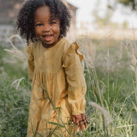 De Little Dutch blooming flower jurk met lange mouw in de kleur warm yellow is een prachtige jurk voor je kleintje. De jurk is gemaakt van een zachte stof en heeft een felle gele kleur, wat zorgt voor frisse en leuke uitstraling. VanZus