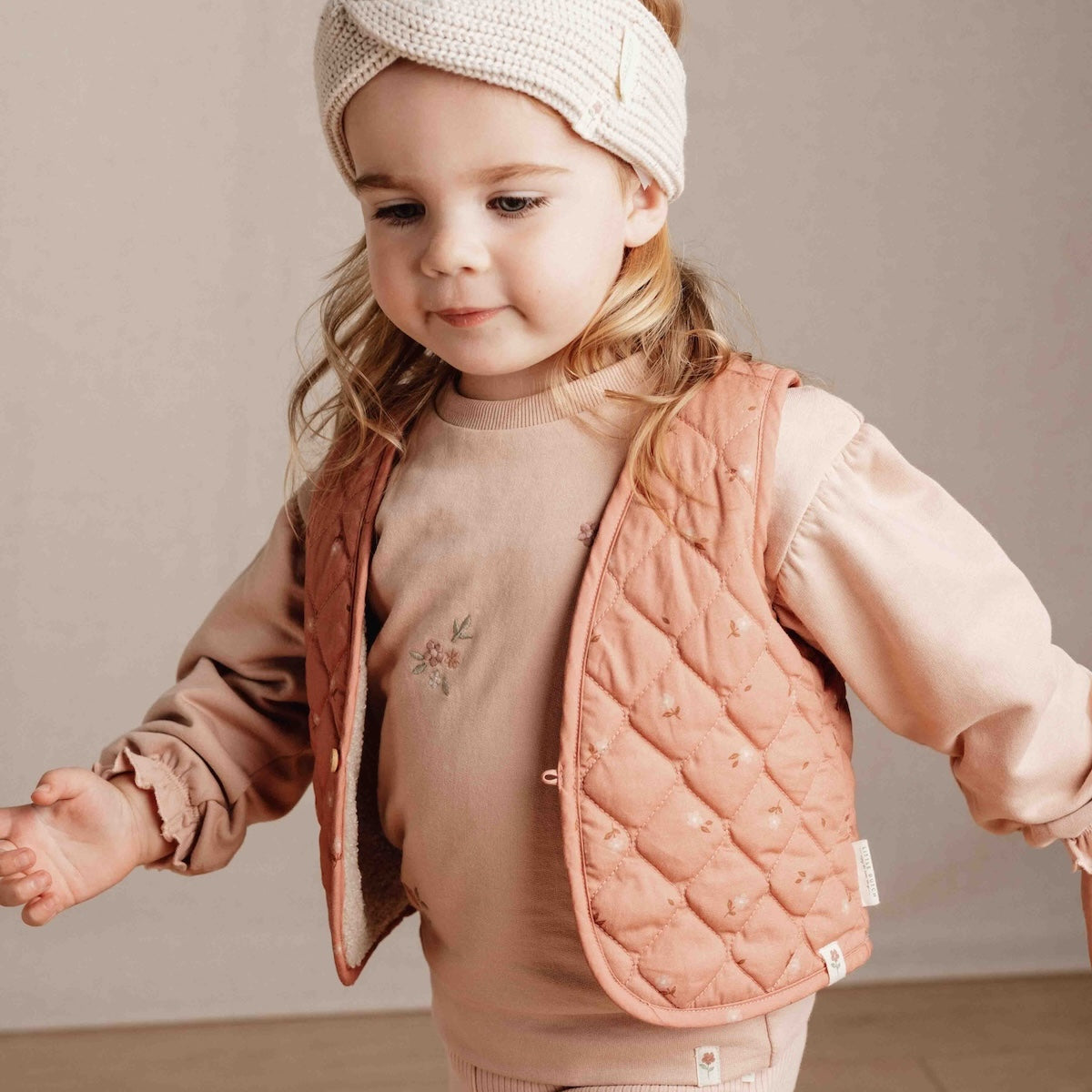 Met het omkeerbaar gilet van Little Dutch in de kleur sand/warm rose blooming flower voeg je een vleugje stijl toe aan de outfit van je kind. Het gilet kan op twee manieren gedragen worden: de kant van de teddystof of de kant met bloemetjesprint. VanZus