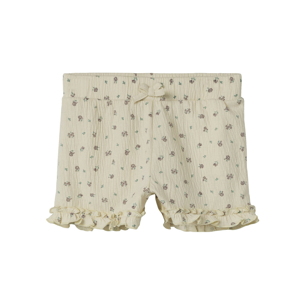 De jannis short in de kleur bleached sand van het merk Name It is een schattige en comfortabele korte broek voor meisjes. Gemaakt van een zachte en soepele stof die perfect is voor zomerse dagen. VanZus