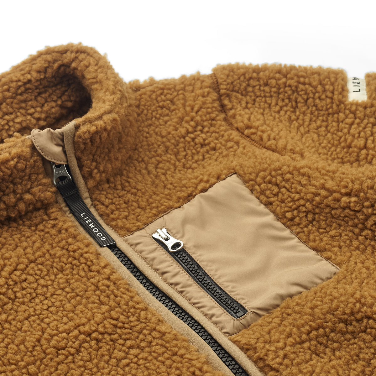 Ben je op zoek naar een fijne en stijlvolle fleece jas voor jouw kleintje voor de koudere wintermaanden? Dan is deze nolan fleece jas in mega golden caramel oat mix een echte must have. VanZus