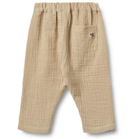 De Wheat ashley broek in de kleur soft sand is een heerlijke zachte broek voor je kleintje. Hij is gemaakt van biologisch katoen en lekker luchtig, perfect voor een lente- of zomerdag. VanZus.