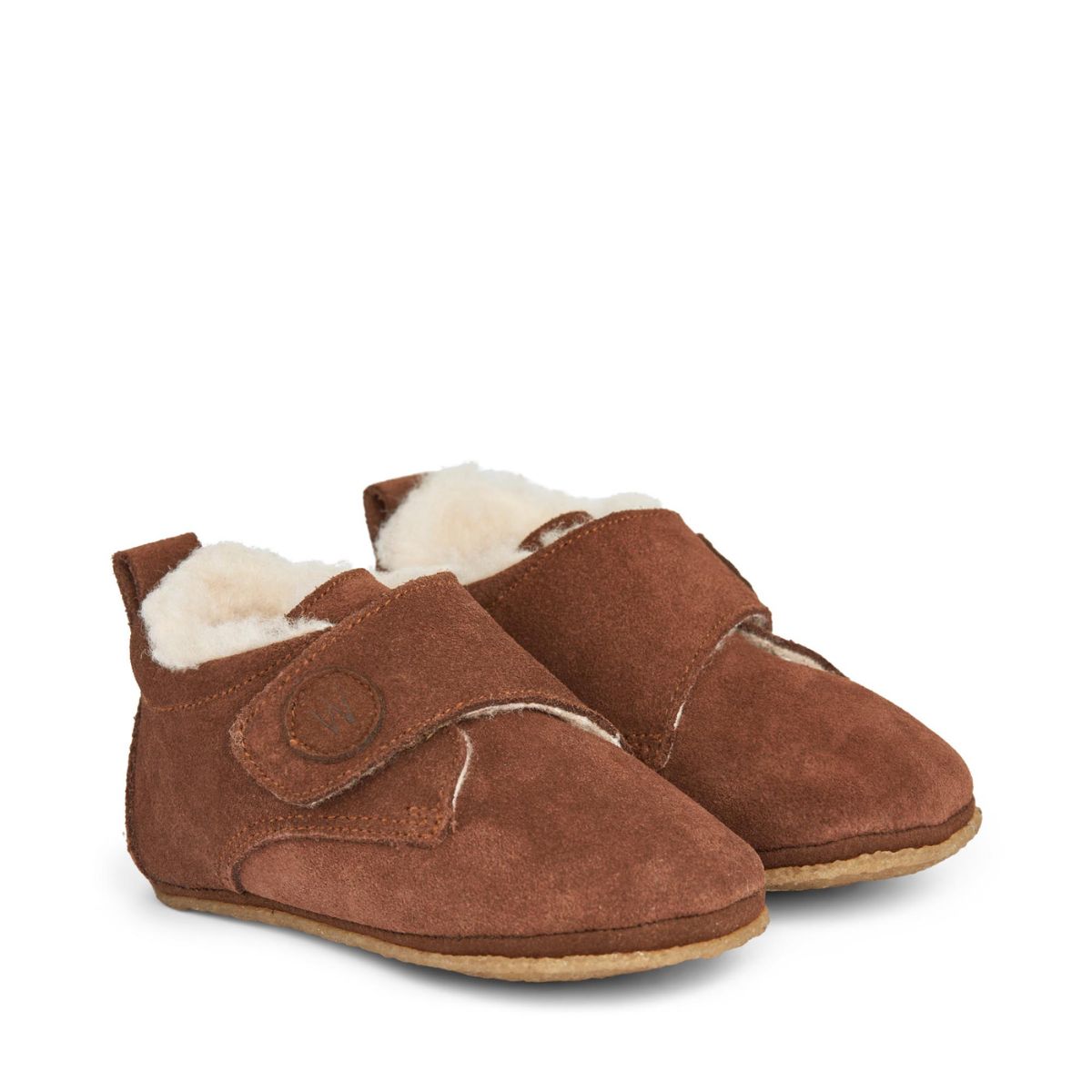 Houd de voetjes van je kleintje warm met deze heerlijke warme en knusse pantoffels met klittenbandsluiting en wollen voering. De Wheat taj sloffen in de kleur cognac zijn zacht, warm en cosy. De pantoffels zijn flexibel, waardoor ook de kleinsten er goed mee kunnen bewegen. VanZus