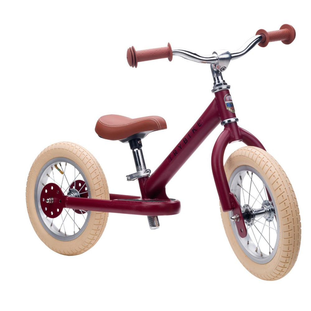 Op avontuur met de steel loopfiets in de kleur  mat rood van Trybike. De metalen tweewieler is geschikt vanaf 2 jaar en leert kinderen lopen en fietsen. Groeit mee met je kind. In diverse kleuren. VanZus
